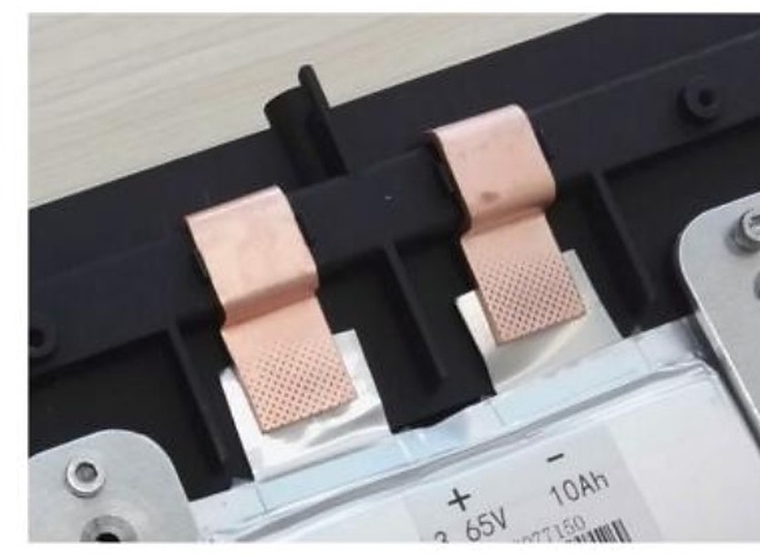 Copper foil tabs ultrasonically welded onto the terminals of a lithium-ion cell