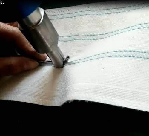 Handheld ultrasonic knife cutting and sealing woven fabric