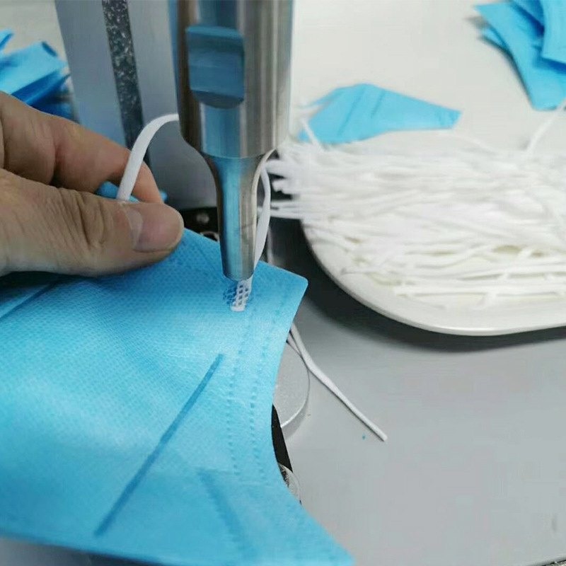 Ultrasonic welding of an ear loop onto a non-woven medical mask