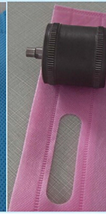 Roller sealing a pink non-woven piece with a slit window