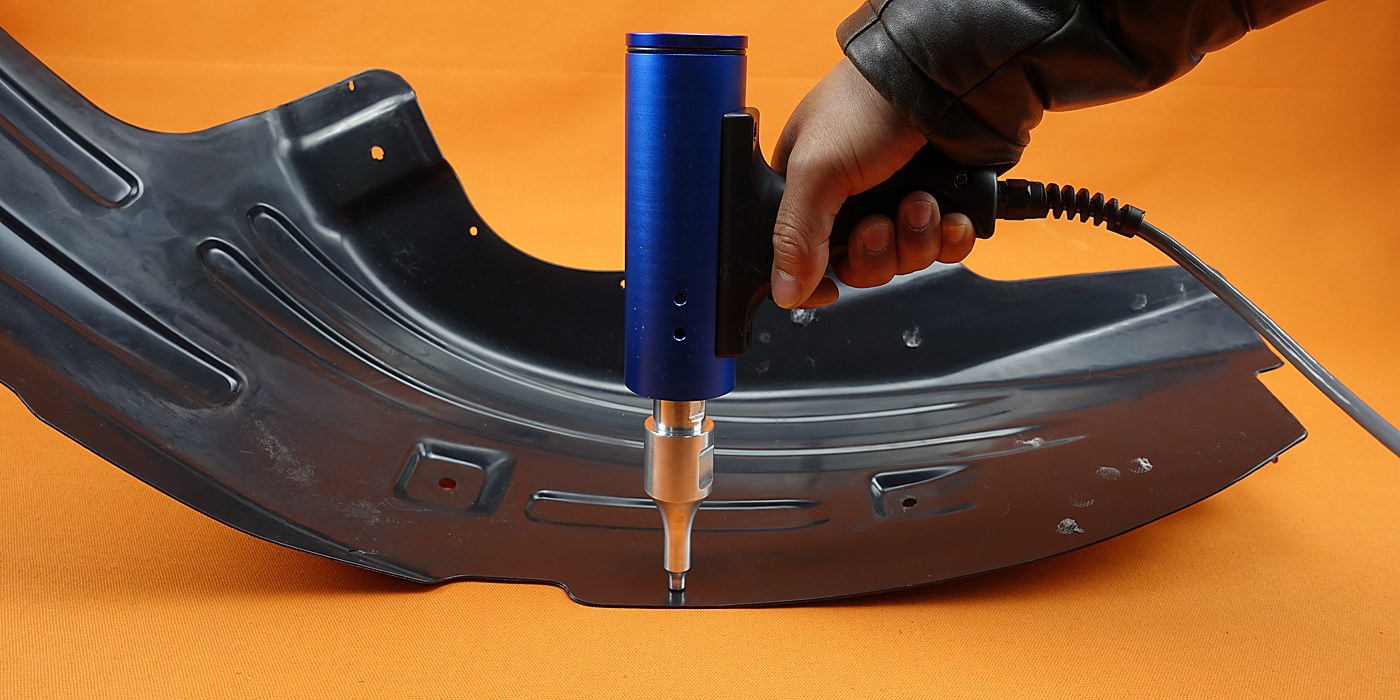 Plastic Processing application &mdash; a handheld ultrasonic welder joining an automotive plastic trim panel